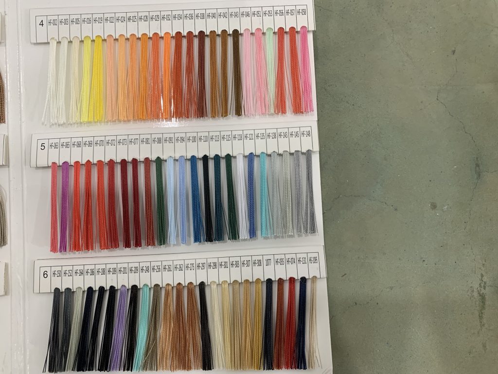 Thread sample chart showing neutral, red, blue, gray, and bright stitching colors
