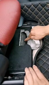 Vehicle identification number stamped beneath a front seat access panel
