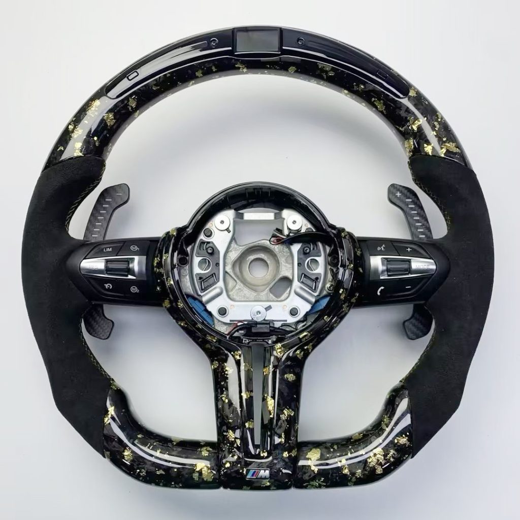 BMW steering wheel with gold-flake forged carbon, black Alcantara, LED display and carbon paddles