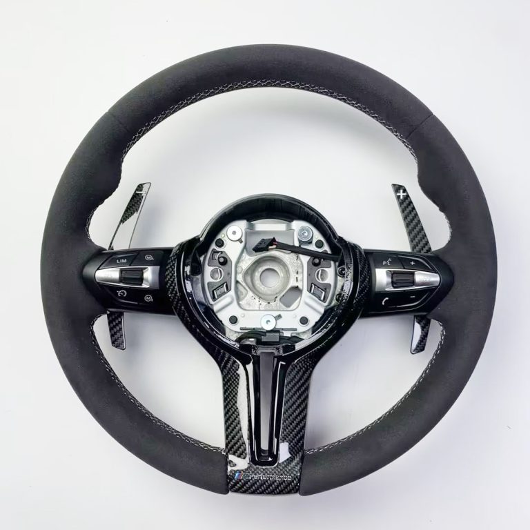 BMW steering wheel with black Alcantara, white stitching, gloss carbon trim and extended carbon paddles