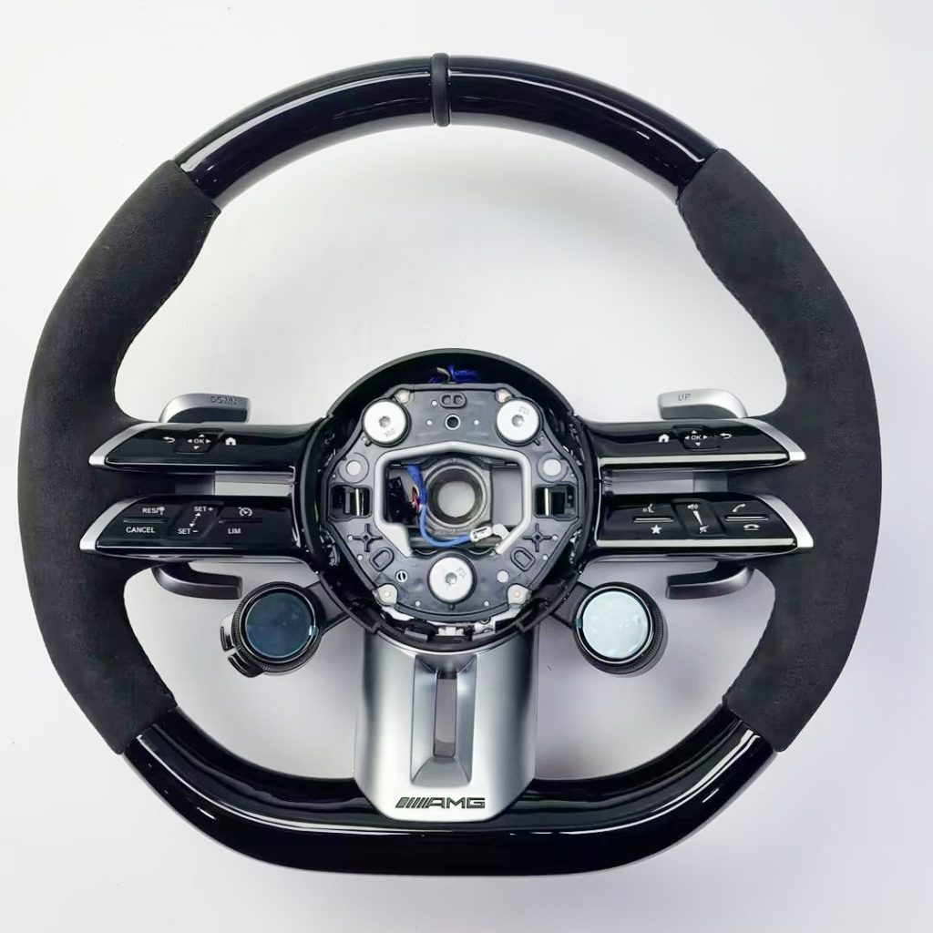 Mercedes-Benz wheel with black wood, black Alcantara, twin OLED controls and a leather center marker